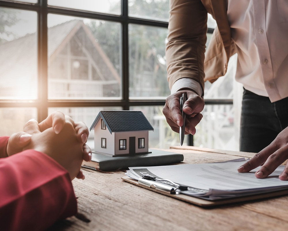An adviser reviewing a property contract — the claims lifecycle AI moves from FNOL to settled
